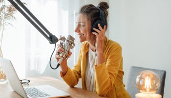 Cheerful,Woman,Podcaster,Recording,Her,Voice,Into,Microphone.,Female,Radio